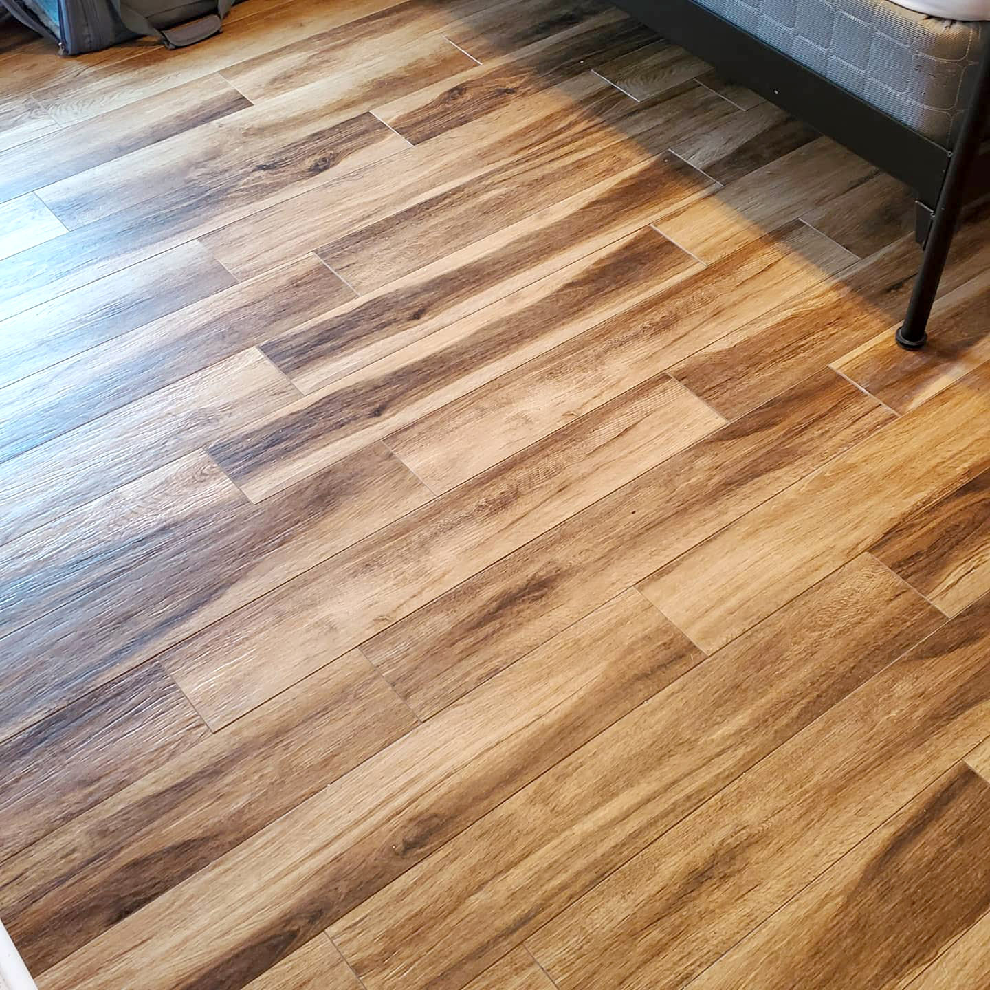 Wood-look tiles in a bathroom - Footprints Floors in Utah County has experts at installing!