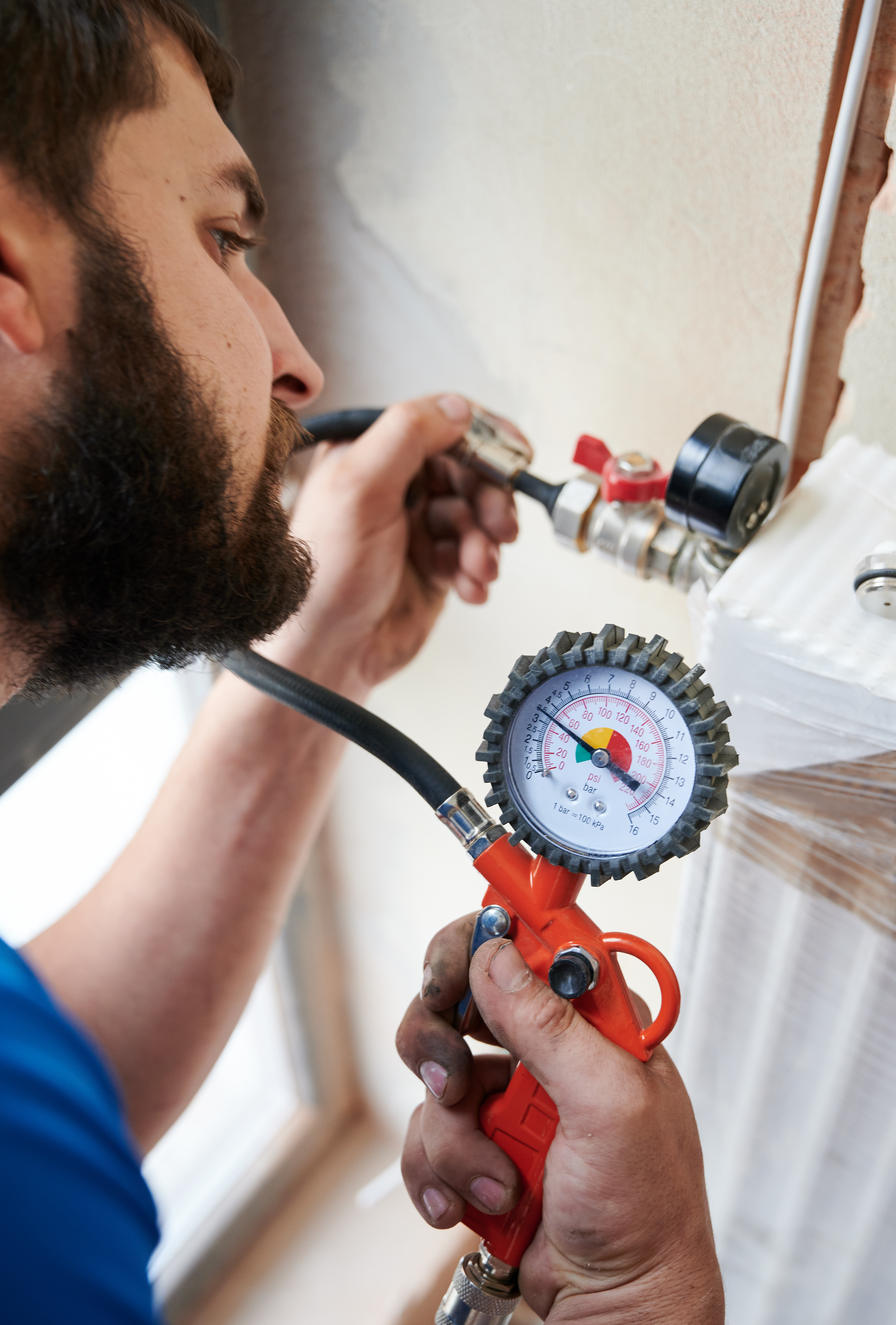 A plumbing expert using plumbing equipment - avoid cheap plumbers in Ohio & North Carolina and choose WyattWorks; a community plumber.