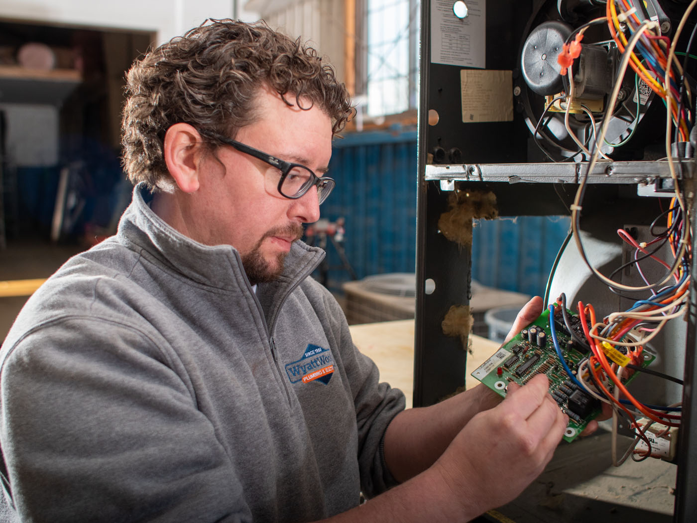 A WyattWorks technician from our heating company in Ohio & North Carolina, {fran_state_abbrev} working on the electrical components from a furance system.