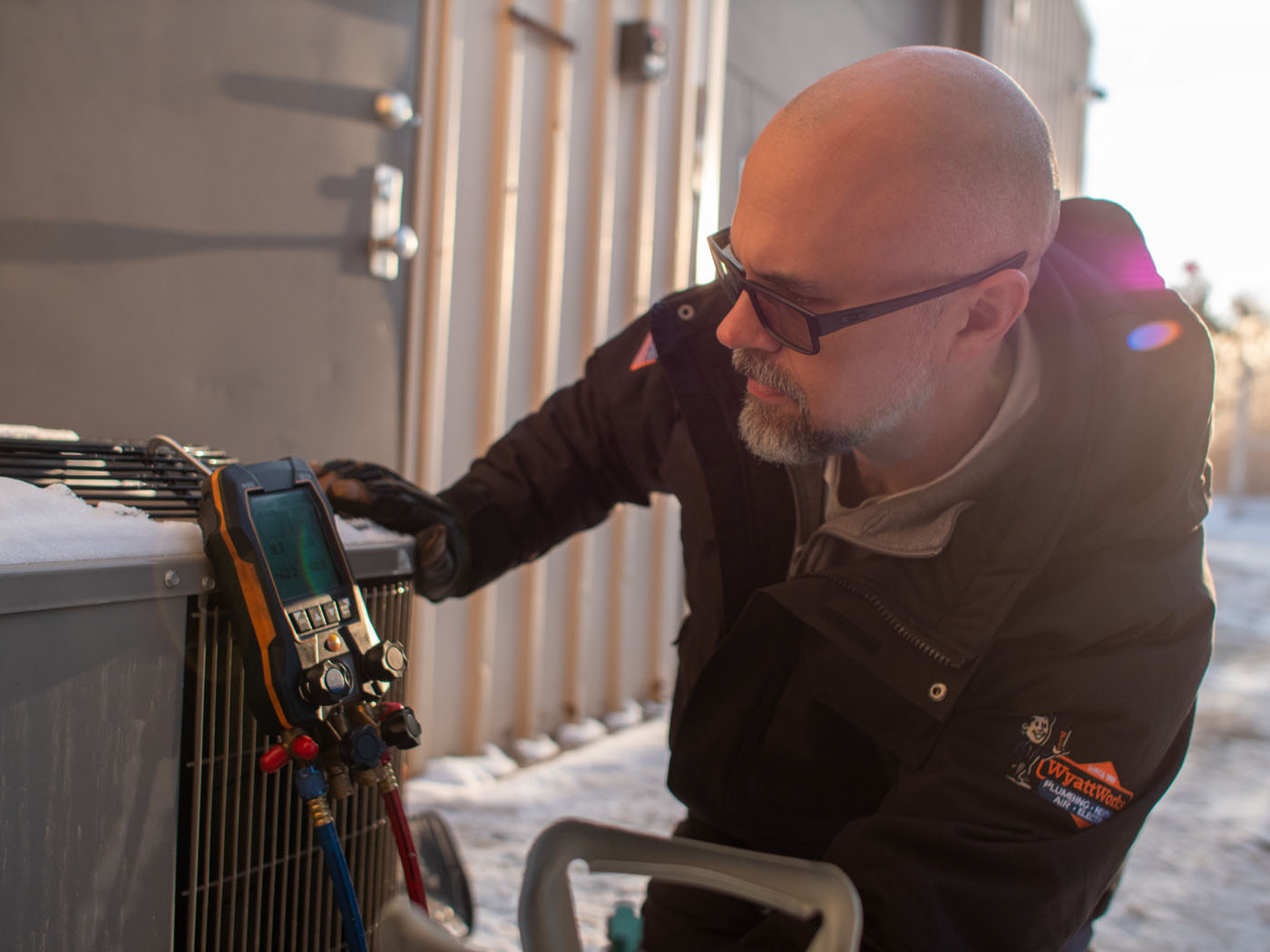 A WyattWorks technician performing an air conditioner service in Ohio & North Carolina, {fran_state_abbrev}.