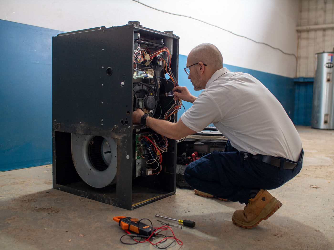 A WyattWorks technician providing HVAC services in Ohio & North Carolina, {fran_state_abbrev} on a heating system.