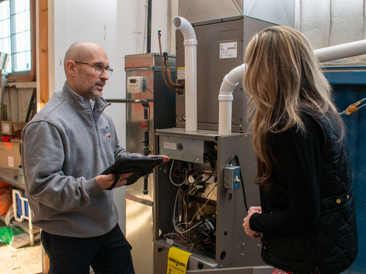 A WyattWorks technician talking to a customer about their Ohio & North Carolina HVAC service.