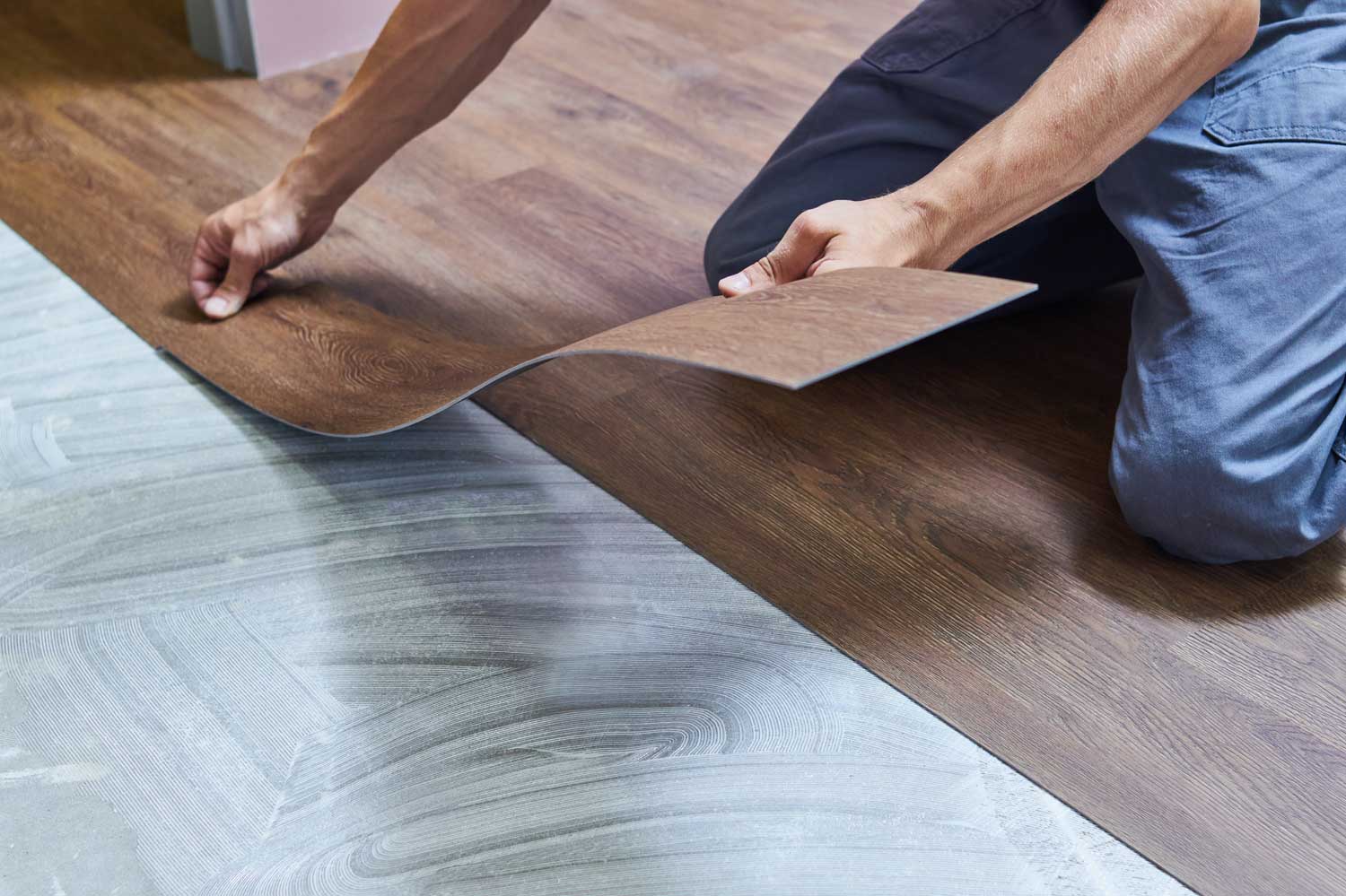 A Footprints Floors professional in Worcester County installs laminate flooring in a home.