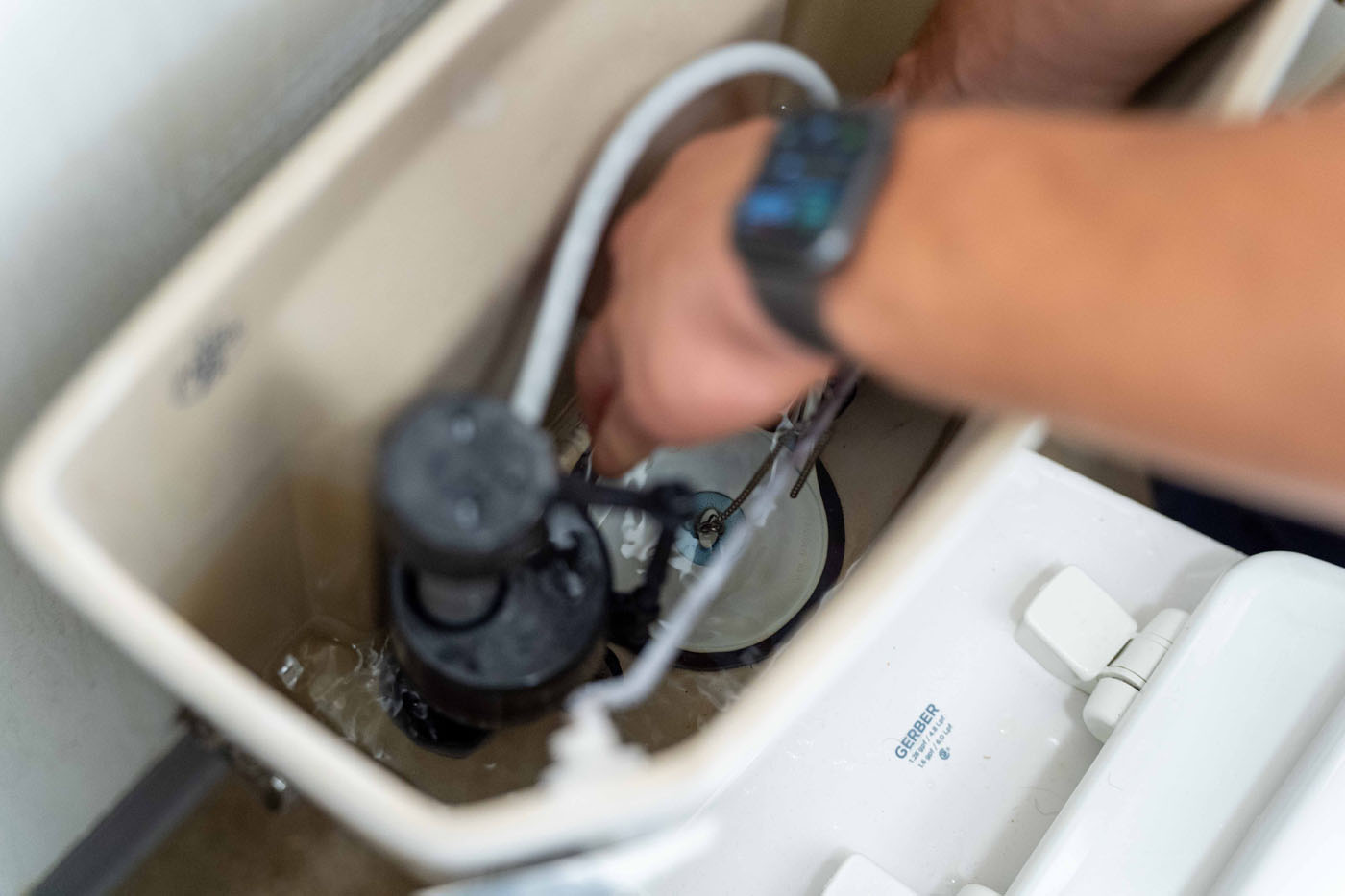 WyattWorks service pro working on a toilet