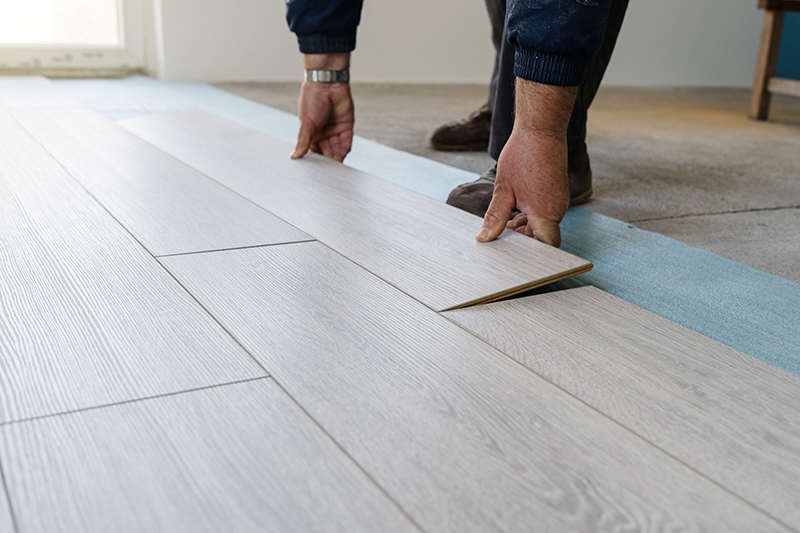 Vinyl being installed - service provided by Footprints Floors in  Huntington / Hauppauge.