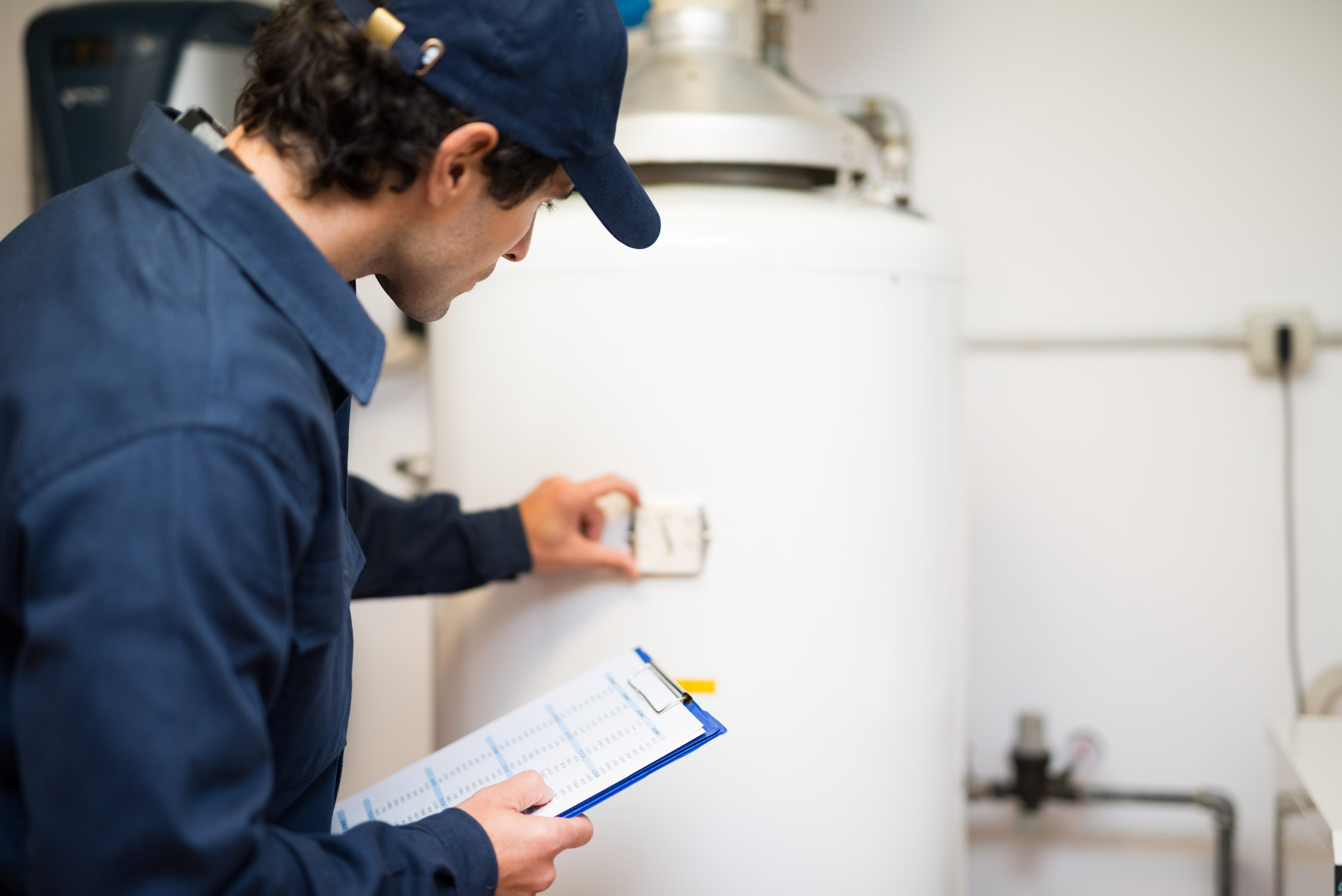 A service provider from WyattWorks servicing a water heater.