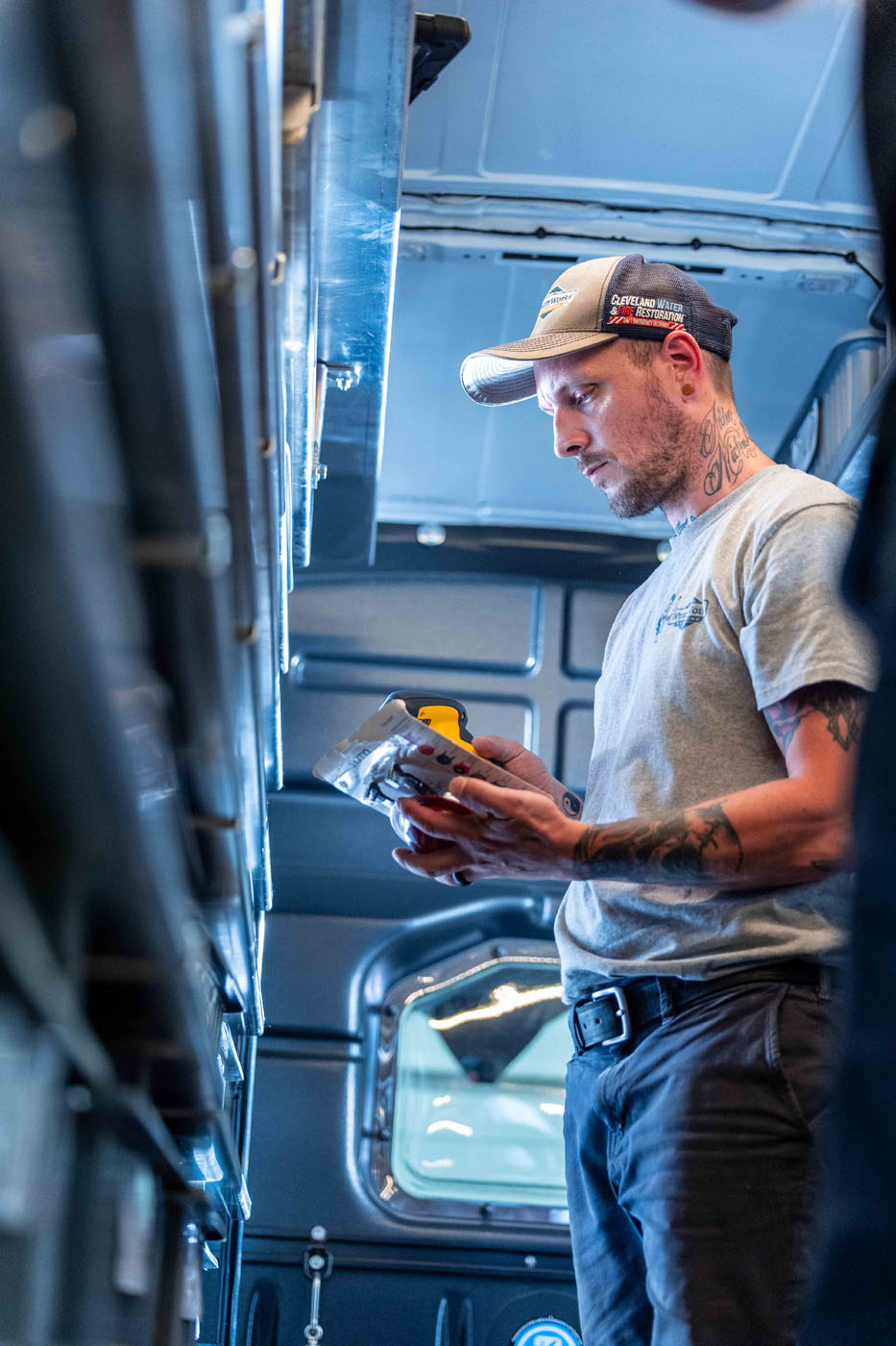 An image of a WyattWorks technician looking at parts and supplies in our service vehicle.