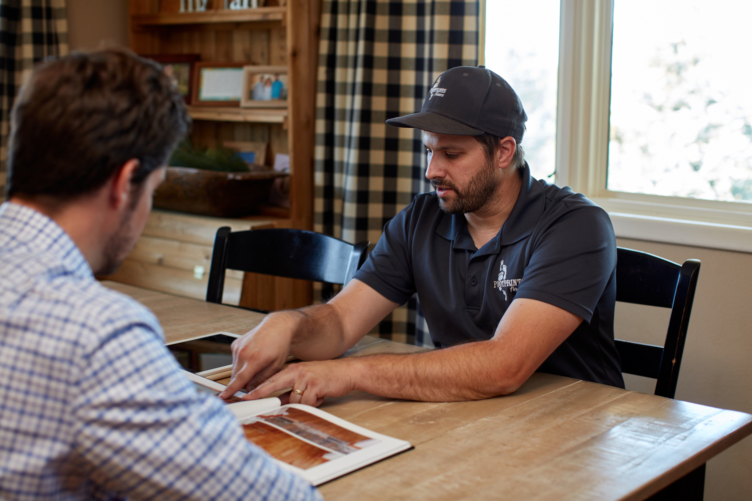 A Footprints Floors professional with a client showing them all the options we provide in Grand Prairie / Mesquite!